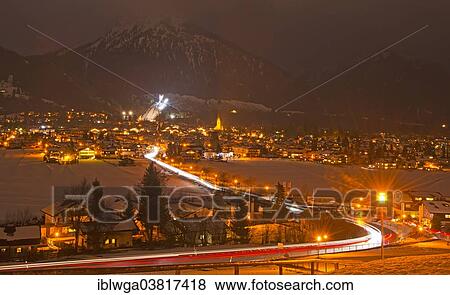 Stock Photo - "Oberstdorf at night, Schattenbergschanze ski jump at the rear, Allgau Alps, Allgau, Bavaria, Germany, Europe". Fotosearch