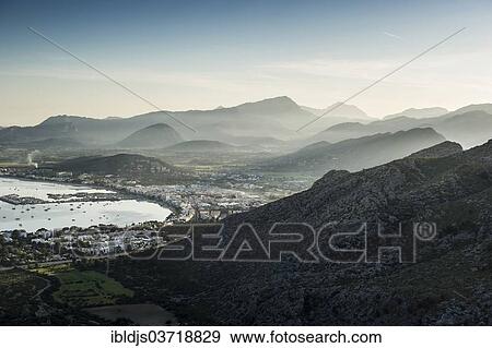 "Ocean bay with city and mountains at dusk, Port de Pollenca, Pollenca, Serra de Tramuntana, Majorca, Balearic Islands, Spain, Europe" View Large Photo Image Stock Photo - "Ocean bay with city and mountains at dusk, Port de Pollenca, Pollenca, Serra de Tramuntana, Majorca, Balearic Islands, Spain, Europe". Fotosearch