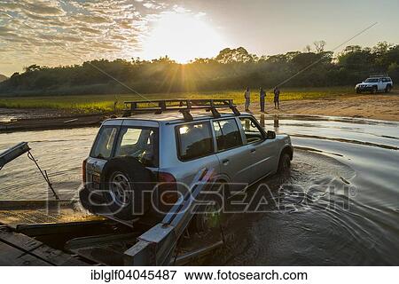 "Off-road vehicle driving off the ferry on the Manambolo river, Bekopaka, Madagascar, Africa" View Large Photo Image Stock Photo - "Off-road vehicle driving off the ferry on the Manambolo river, Bekopaka, Madagascar, Africa". Fotosearch
