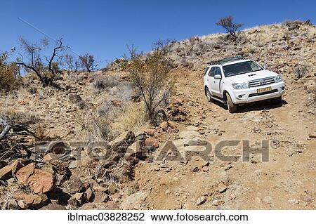 "Off-road vehicle tackling a dirt track, Spreetshoogte, Namibia, Africa" View Large Photo Image Stock Image - "Off-road vehicle tackling a dirt track, Spreetshoogte, Namibia, Africa". Fotosearch
