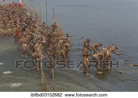 "Offering parts of their first meal in their new lives as part of the initiation of new sadhus at the Sangam, the confluence of the rivers Ganges, Yamuna and Saraswati, during Kumbha Mela festival, Allahabad, Uttar Pradesh, India, Asia" View Large Photo Image Stock Image - "Offering parts of their first meal in their new lives as part of the initiation of new sadhus at the Sangam, the confluence of the rivers Ganges, Yamuna and Saraswati, during Kumbha Mela festival, Allahabad, Uttar Pradesh, India, Asia". Fotosearch