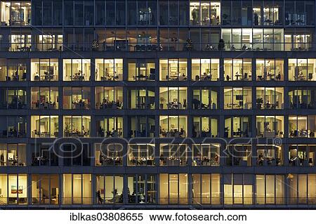 Stock Photography - "Office buildings with lighted windows, people at work, Media Harbour, Dusseldorf, North Rhine-Westphalia, Germany, Europe". Fotosearch