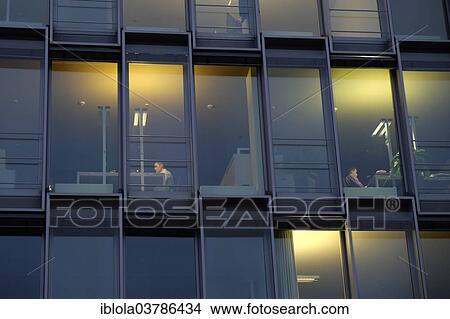 "Office workers at desks behind modern glass facade, Rheinauhafen, Cologne, North Rhine-Westphalia, Germany, Europe" View Large Photo Image Picture - "Office workers at desks behind modern glass facade, Rheinauhafen, Cologne, North Rhine-Westphalia, Germany, Europe". Fotosearch