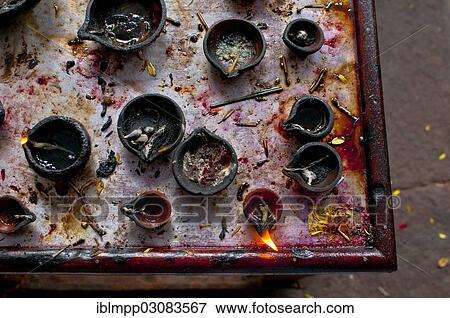 Oil lamps in an Indian temple View Large Photo Image Stock Photo - Oil lamps in an Indian temple. Fotosearch