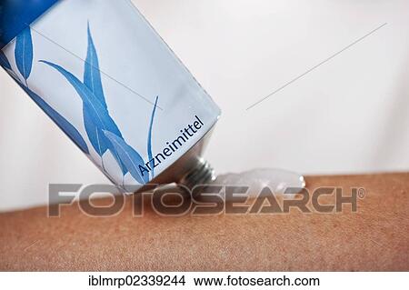 Ointment is applied to an arm View Large Photo Image Picture - Ointment is applied to an arm. Fotosearch