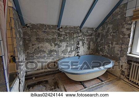 Old bathroom, removed tiles, old bathtub, bathroom renovation View Large Photo Image Picture - Old bathroom, removed tiles, old bathtub, bathroom renovation. Fotosearch