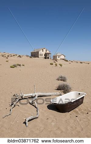 "Old bathtub and houses of a former diamond miners settlement that is slowly covered by the sand of the Namib Desert, Kolmanskop, ÇKaras, Namibia, Africa" View Large Photo Image Stock Image - "Old bathtub and houses of a former diamond miners settlement that is slowly covered by the sand of the Namib Desert, Kolmanskop, ÇKaras, Namibia, Africa". Fotosearch
