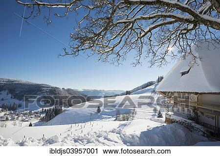 Stock Image - "Old Black Forest house and snow-covered landscape, Muggenbrunn, Todtnau, Black Forest, Baden-Wuerttemberg, Germany, Europe". Fotosearch