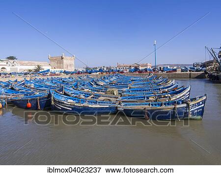 Stock Photo - "Old blue fishing boats in the port of Essaouira, Unesco World Heritage Site, Morocco, Africa". Fotosearch