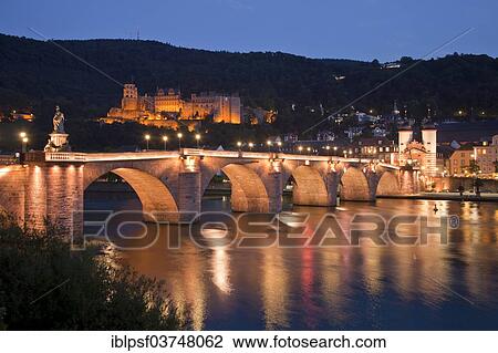 Stock Image - "Old Bridge and the Neckar River, at back the Heidelberger Schloss, Heidelberg Castle, at night, Heidelberg, Baden-Wurttemberg, Germany, Europe". Fotosearch