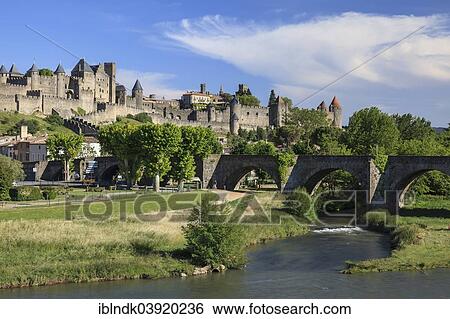 Stock Photograph - "Old bridge over the Aude, behind the medieval fortress of Carcassonne, Cite de Carcassonne, Carcassonne, Departement Aude, Languedoc-Roussillon, France, Europe". Fotosearch