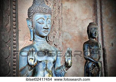 Old Buddha in front of a temple in Vientiane, Laos, Southeast Asia, Asia View Large Photo Image Picture - Old Buddha in front of a temple in Vientiane, Laos, Southeast Asia, Asia. Fotosearch