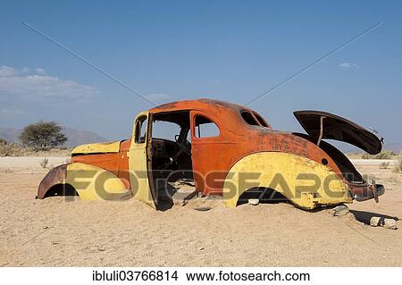 "Old car wreck stuck in the sand, Solitaire, Khomas Region, Namibia, Africa" View Large Photo Image Picture - "Old car wreck stuck in the sand, Solitaire, Khomas Region, Namibia, Africa". Fotosearch