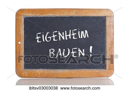 Stock Photo - "Old chalkboard, lettering """"EIGENHEIM BAUEN"""", German for """"BUILD A HOUSE""""". Fotosearch