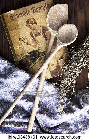 "Old cookbook with wooden spoons, kitchen towel and dried mugwort on a wooden board, Germany, Europe" View Large Photo Image Stock Image - "Old cookbook with wooden spoons, kitchen towel and dried mugwort on a wooden board, Germany, Europe". Fotosearch