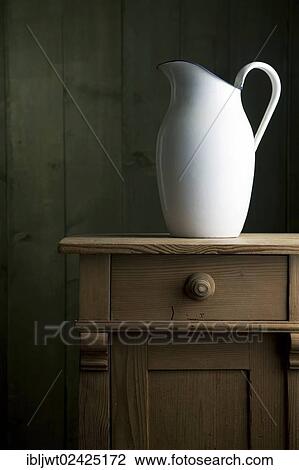 Old enamel jug on a small chest of drawers View Large Photo Image Stock Image - Old enamel jug on a small chest of drawers. Fotosearch