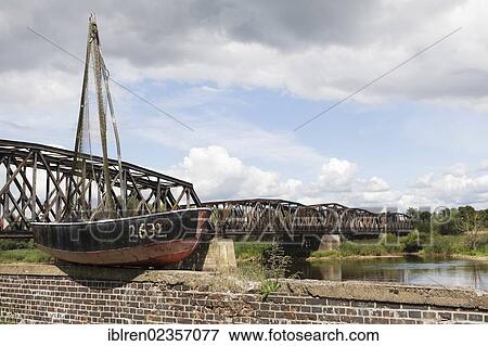 "Old fishing boat on the border river Oder, Polish-German border, Kuestrin to Kostrzyn, life buoy with the inscription """"Berlin DDR"""", Brandenburg, Germany, Europe" View Large Photo Image Stock Photo - "Old fishing boat on the border river Oder, Polish-German border, Kuestrin to Kostrzyn, life buoy with the inscription """"Berlin DDR"""", Brandenburg, Germany, Europe". Fotosearch