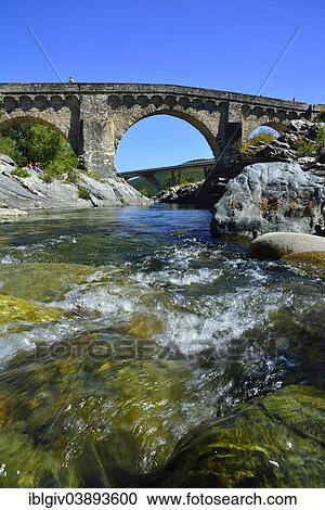 Stock Image - "Old Genovese Bridge and the new dual carriageway bridge over the Tavignano River, near Altiani, Corte, Corsica, France, Europe". Fotosearch