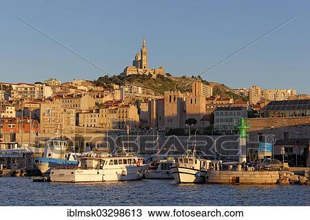 Stock Image - "Old harbour and Notre Dame de la Garde, landmark of the city, evening mood, historic center, Marseille, Departement Bouches-du-Rhone, Region Provence-Alpes-Cote dâ€™Azur dâ€™Azur, France, Europe". Fotosearch