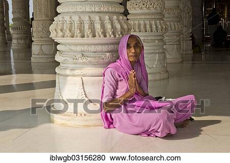 "Old Indian woman in a sari sitting on the floor in prayer, in front of an ornate marble column, at Shri Swaminarayan Mandir, a Hindu temple of the Swaminarayana sect, Bhuj, Gujarat, India, Asia" View Large Photo Image Stock Image - "Old Indian woman in a sari sitting on the floor in prayer, in front of an ornate marble column, at Shri Swaminarayan Mandir, a Hindu temple of the Swaminarayana sect, Bhuj, Gujarat, India, Asia". Fotosearch