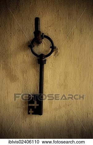 Old large key hanging on a wall View Large Photo Image Stock Image - Old large key hanging on a wall. Fotosearch