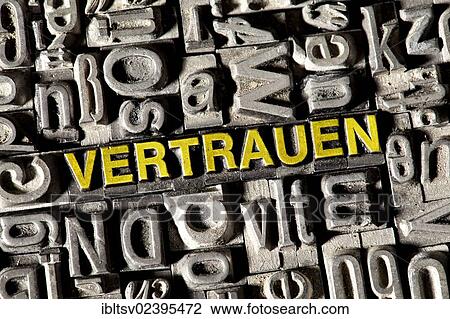 Stock Image - "Old lead letters forming the word """"VERTRAUEN"""", German for """"TRUST""""". Fotosearch