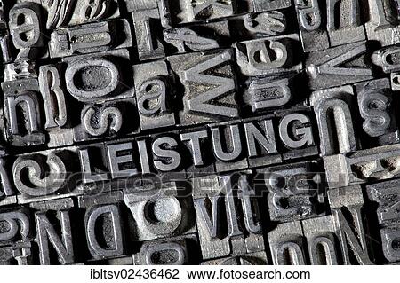 Stock Image - "Old lead letters forming the word """"LEISTUNG"""", German for """"POWER""""". Fotosearch