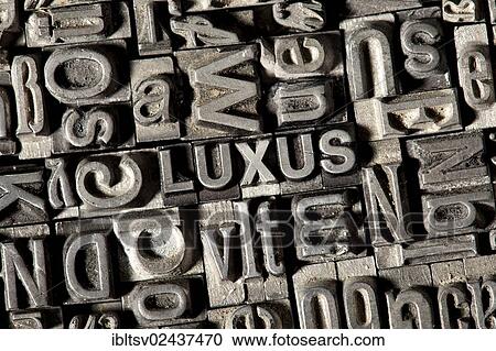 Stock Image - "Old lead letters forming the word """"LUXUS"""", German for """"LUXURY""""". Fotosearch