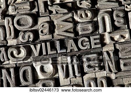 Stock Image - Old lead letters forming the word VILLAGE. Fotosearch