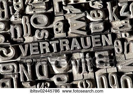 Stock Photograph - "Old lead letters forming the word VERTRAUEN, German for trust". Fotosearch