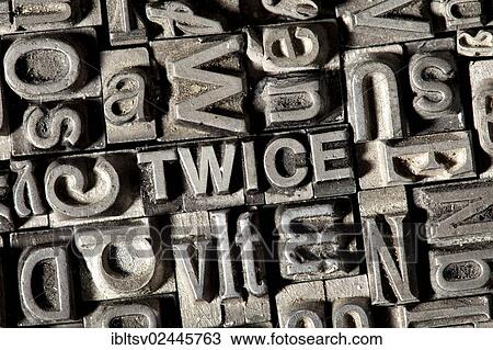 Stock Image - Old lead letters forming the word TWICE. Fotosearch