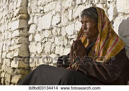 "Old local woman praying in front of a brick wall, Muktinath, Lower Mustang, Nepal, Asia" View Large Photo Image Picture - "Old local woman praying in front of a brick wall, Muktinath, Lower Mustang, Nepal, Asia". Fotosearch