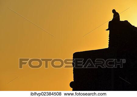 "Old man sitting on the harbour wall of the harbour at Ammoudi at sunset, near Oia, Santorini, Cyclades, Greek Islands, Greece, Europe" View Large Photo Image Stock Photo - "Old man sitting on the harbour wall of the harbour at Ammoudi at sunset, near Oia, Santorini, Cyclades, Greek Islands, Greece, Europe". Fotosearch