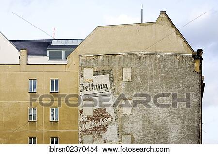 Picture - "Old newspaper advertising on the wall of a building on the corner of Unter den Linden - Friedrichstrasse, visible after the demolition of the old Hotel Unter den Linden, Berlin, Germany, Europe". Fotosearch