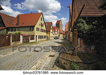 "Old residential buildings in an alley, Rothenburg Tower at the rear and an old well on the right, Dinkelsbuhl, Middle Franconia, Bavaria, Germany, Europe" View Large Photo Image Stock Photography - "Old residential buildings in an alley, Rothenburg Tower at the rear and an old well on the right, Dinkelsbuhl, Middle Franconia, Bavaria, Germany, Europe". Fotosearch
