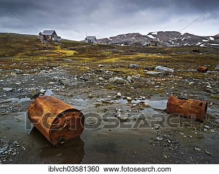 "Old rusty barrels, abandoned houses at back, Krossfjorden, Haakon VII Land, Spitsbergen Island, Svalbard Archipelago, Svalbard and Jan Mayen, Norway, Europe" View Large Photo Image Stock Image - "Old rusty barrels, abandoned houses at back, Krossfjorden, Haakon VII Land, Spitsbergen Island, Svalbard Archipelago, Svalbard and Jan Mayen, Norway, Europe". Fotosearch