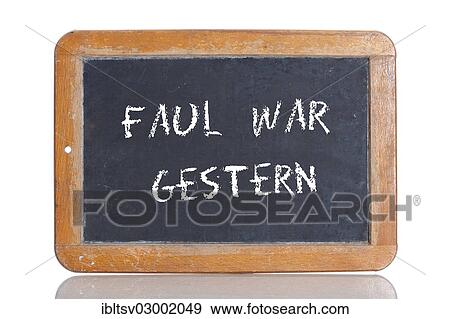 Stock Photo - "Old school blackboard with the phrase FAUL WAR GESTERN, German for Laziness is a thing of the past". Fotosearch
