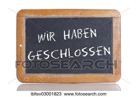 Stock Image - "Old school blackboard with the words WIR HABEN GESCHLOSSEN, German for We are closed". Fotosearch