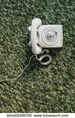 Stock Image - Old telephone on carpet. Fotosearch