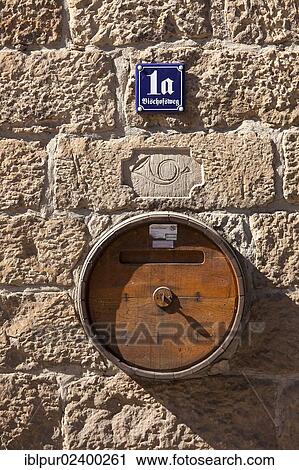 Stock Image - "Old wine barrel as a mailbox, detail on a building in the Bischofspresse complex in Radebeul Zitzschewig, Winzerhaus, Saxony, Germany, Europe". Fotosearch