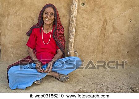 "Old woman sitting on the ground in front of her house, Wuste Thar, Rajasthan, India, Asia" View Large Photo Image Stock Image - "Old woman sitting on the ground in front of her house, Wuste Thar, Rajasthan, India, Asia". Fotosearch
