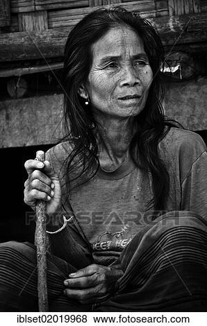 "Old woman with a stick sitting in front of a bamboo hut, in a village on the Mekong River, Laos, Southeast Asia, Asia" View Large Photo Image Stock Photo - "Old woman with a stick sitting in front of a bamboo hut, in a village on the Mekong River, Laos, Southeast Asia, Asia". Fotosearch