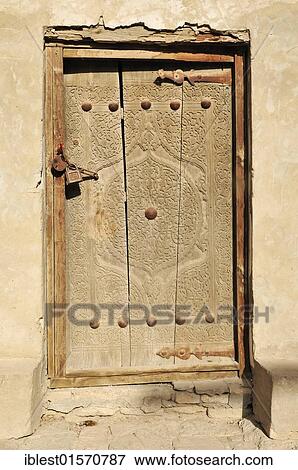 Stock Photo - "Old wooden door in the historic adobe town of Khiva, Chiva, Ichan Kala, Silk Road, Unesco World Heritage Site, Uzbekistan, Central Asia, Asia". Fotosearch