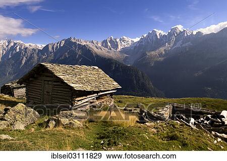 "Old wooden hut with slated roof, peaks of the Bregaglia Range at back, Soglio, Bergell, Canton of Graubunden, Switzerland, Europe" View Large Photo Image Stock Photo - "Old wooden hut with slated roof, peaks of the Bregaglia Range at back, Soglio, Bergell, Canton of Graubunden, Switzerland, Europe". Fotosearch