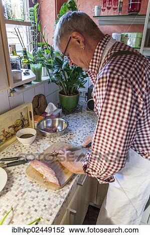 "Older man, 60 +, cooking in the kitchen, cutting meat, Baden-Wuerttemberg, Germany, Europe" View Large Photo Image Stock Image - "Older man, 60 +, cooking in the kitchen, cutting meat, Baden-Wuerttemberg, Germany, Europe". Fotosearch