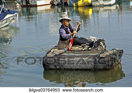 "Older woman paddling over a canal in a makeshift raft, Sai Kung, Hong Kong, China, Asia" View Large Photo Image Stock Image - "Older woman paddling over a canal in a makeshift raft, Sai Kung, Hong Kong, China, Asia". Fotosearch