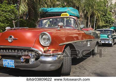 Stock Image - "Oldsmobile, classic car parked in the streets of Havana, Havana, Cuba, North America". Fotosearch