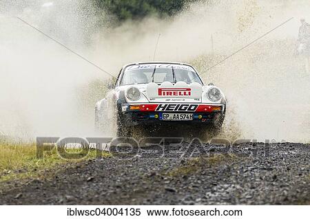 "Oldtimer Eifel Rallye Festival 2014, crossing a water hole, WP 1 Bosch Super Stage, Porsche 911, Daun, Vulkaneifel, Eifel, Rhineland-Palatinate, Germany, Europe" View Large Photo Image Stock Photography - "Oldtimer Eifel Rallye Festival 2014, crossing a water hole, WP 1 Bosch Super Stage, Porsche 911, Daun, Vulkaneifel, Eifel, Rhineland-Palatinate, Germany, Europe". Fotosearch