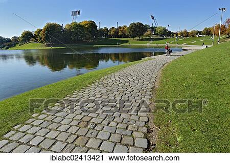 Olympiapark gardens with flood lights and lake Olympiasee, Munich, Bavaria, Germany, Europe View Large Photo Image Stock Image - Olympiapark gardens with flood lights and lake Olympiasee, Munich, Bavaria, Germany, Europe. Fotosearch