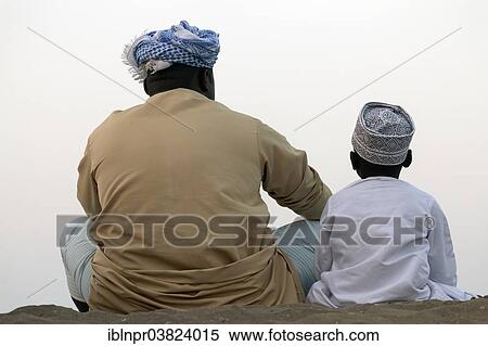 "Omanis, father and son, wearing traditional dress, from behind, Barka, Al-Batinah province, Oman, Arabian Peninsula, Asia" View Large Photo Image Stock Photography - "Omanis, father and son, wearing traditional dress, from behind, Barka, Al-Batinah province, Oman, Arabian Peninsula, Asia". Fotosearch